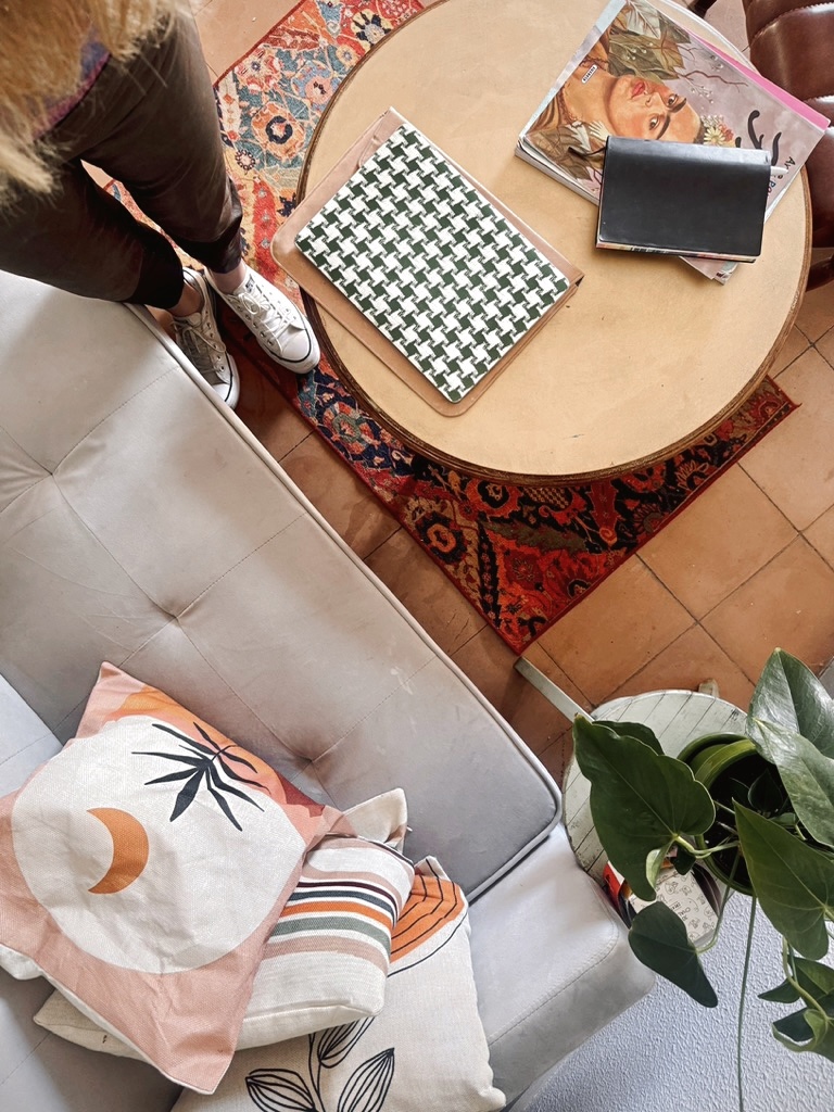 A picture of a round desk and a comfortable sofa, Zsofia's work space